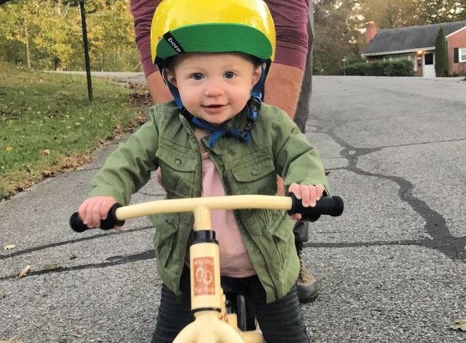 Father teaching child to ride a bicycle