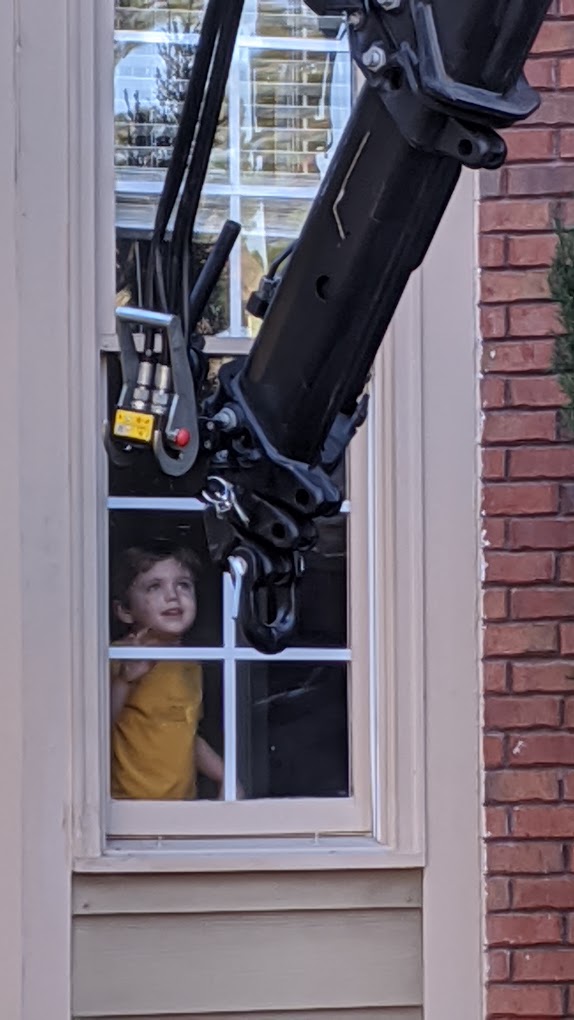 Child looks at equipment through window.