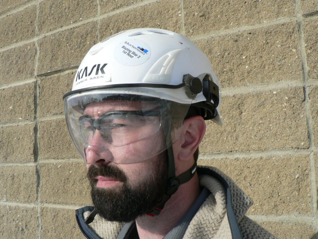 Man wearing a Type II helmet, which is designed with a chin strap that helps protect from lateral impact.