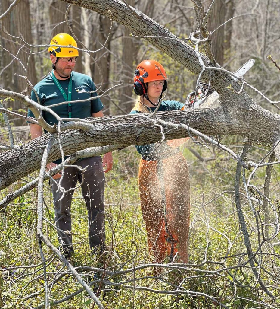 student learns to use a chain saw