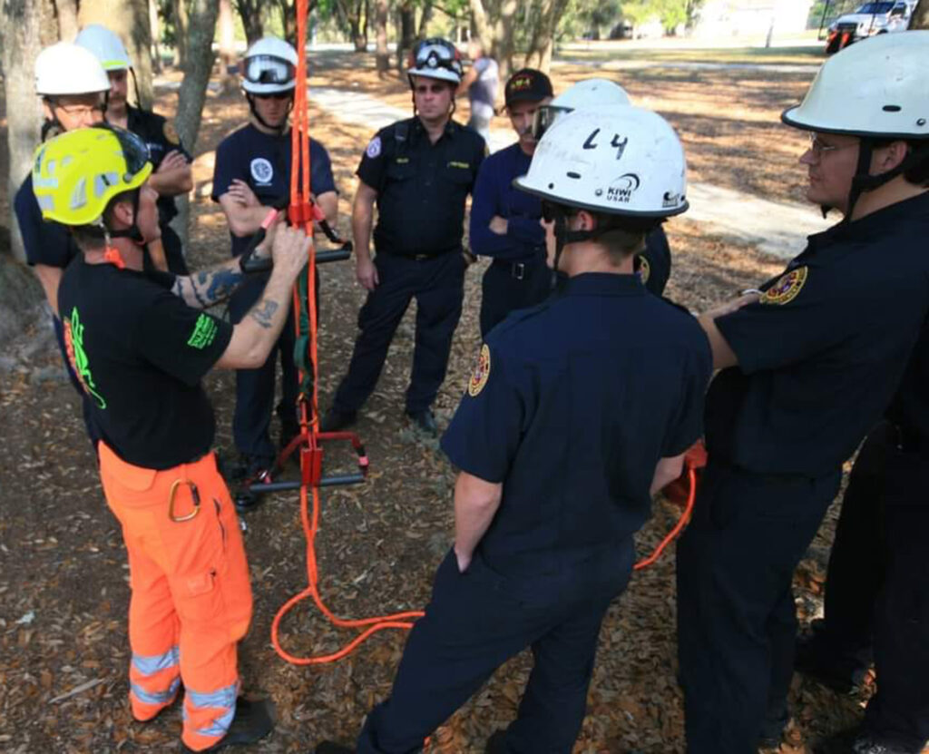 Scotty Olson training on rope skills with a crew of firefighters. Photo by David Graham.