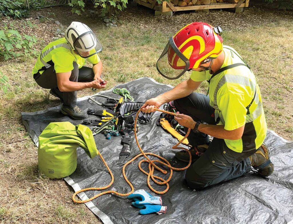 Karsten Foerster, left, and Craig Bachmann perform a pre-climb gear inspection. When doing gear inspections, don’t have the climber look over his or her own gear, but instead, swap it with another crew member.