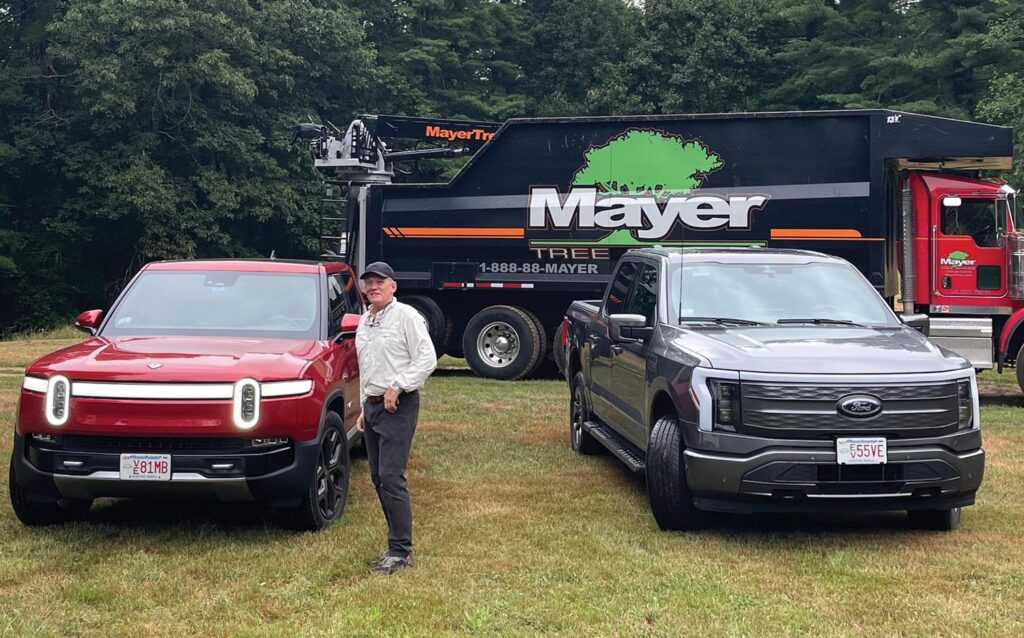 Dan Mayer, owner of Mayer Tree Service, a 32-year TCIA member company based in Essex, Massachusetts, with his Rivian R1T all-electric pickup truck.