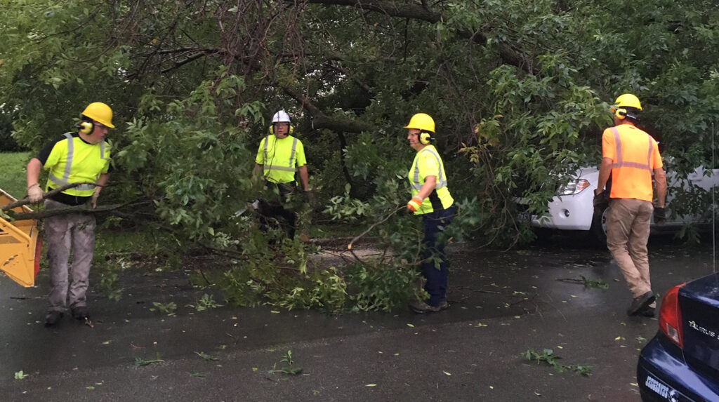A tree crew with the city of Dubuque, Iowa, cleans up after a derecho passed through on July 15, 2024.